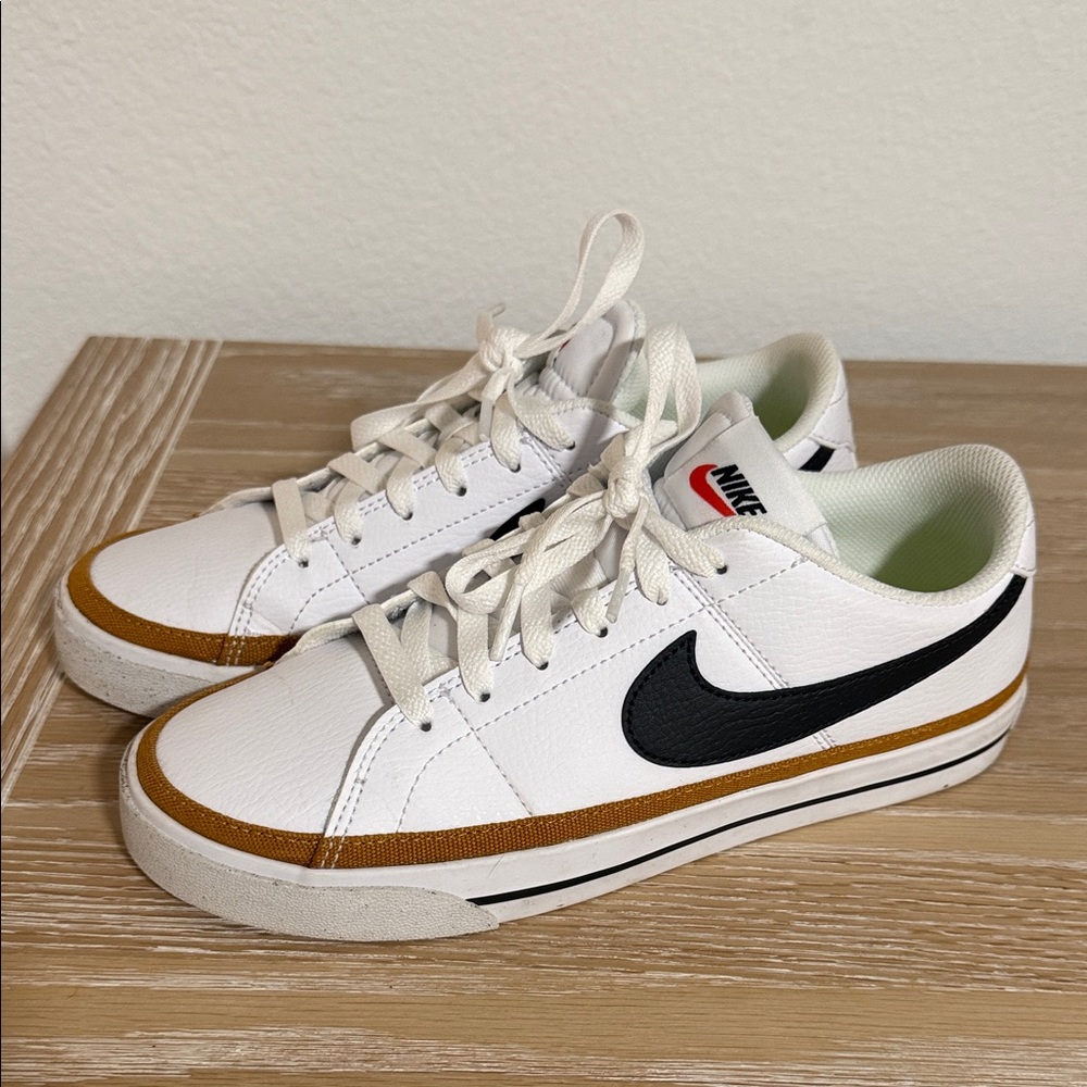 Nike White Sneakers with Black Swoosh and Gold Trim